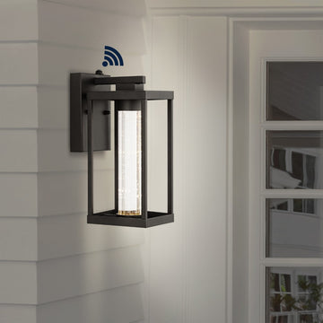 Juno 4.75" Industrial Vintage Iron/Glass Seeded Glass with Dusk-to-Dawn Sensor Integrated LED Outdoor Sconce - JONATHAN Y